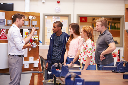 Teacher with students in technical class