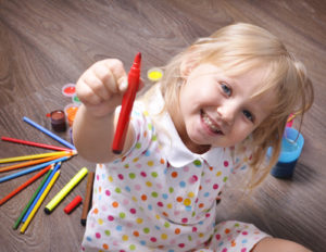 Young girl playing with art supplies