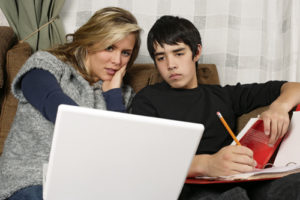 Mother and teen son doing homework