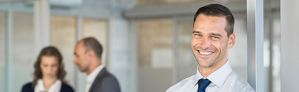 Businessman with colleagues in background