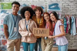 Group of volunteers with donate sign