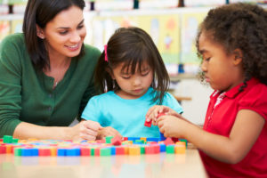 Teacher with two young students