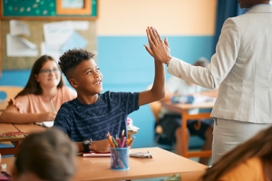 Student high-fiving teacher