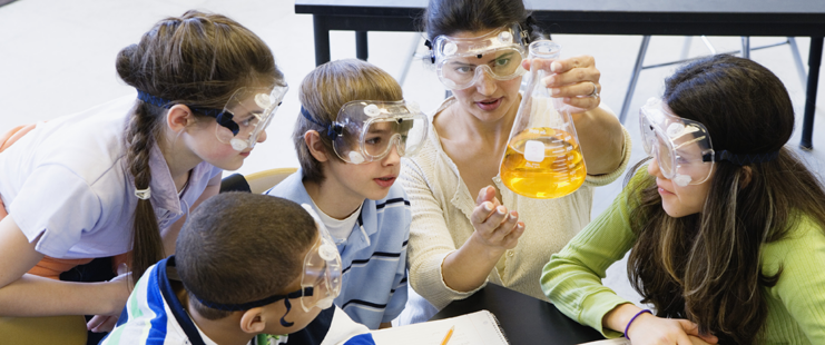 Teacher and students in chemistry lab