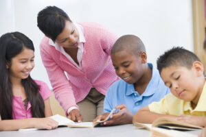 Teacher working with students who are reading