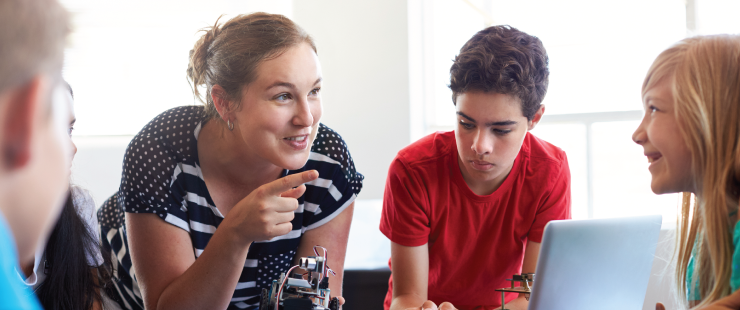 Teacher talking to students about robotics