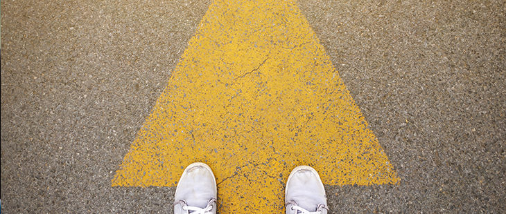 Feet at base of arrow in the street