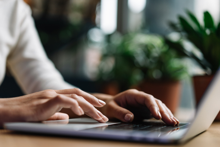 hands typing on a laptop