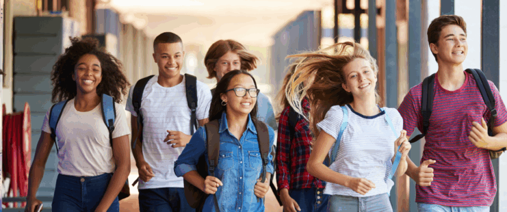 Teens running in school hallway