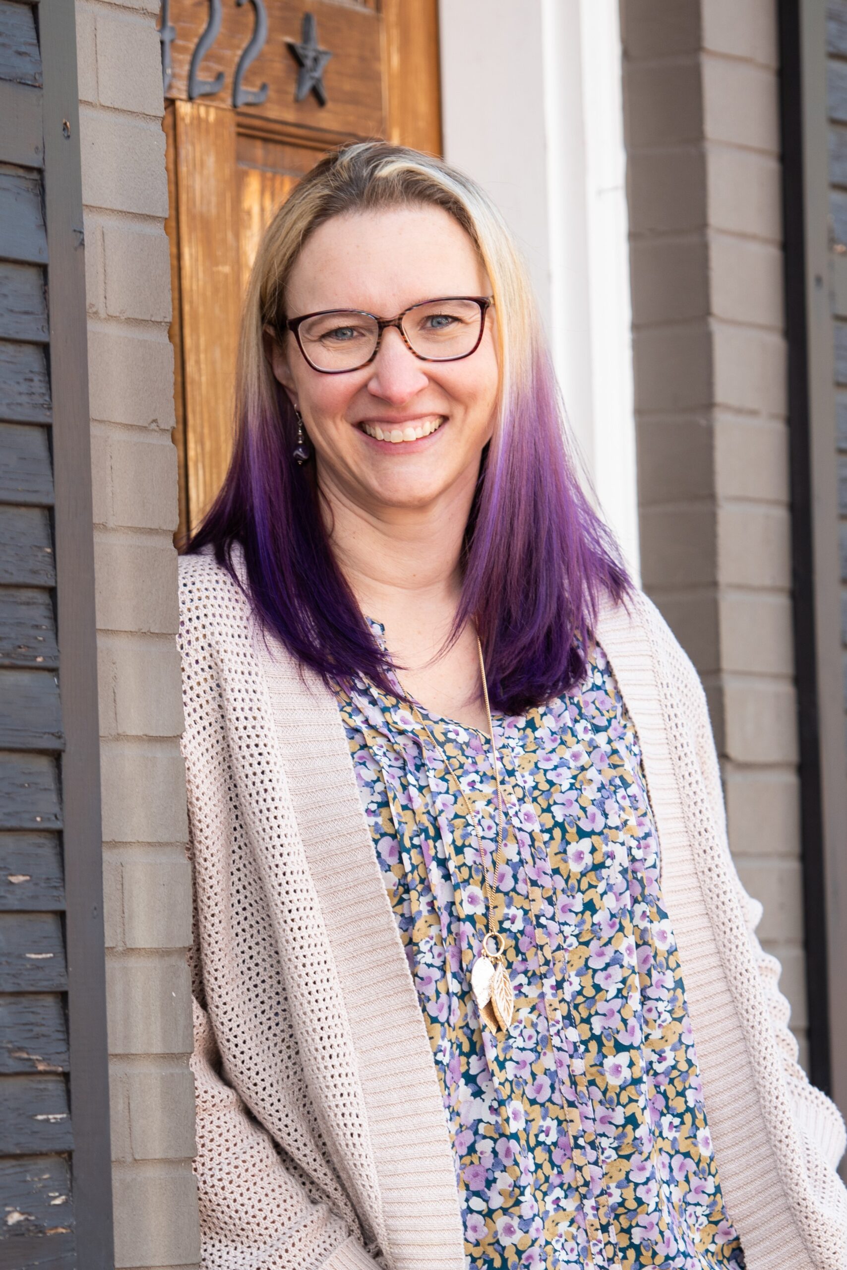 Image of smiling woman standing in a doorway
