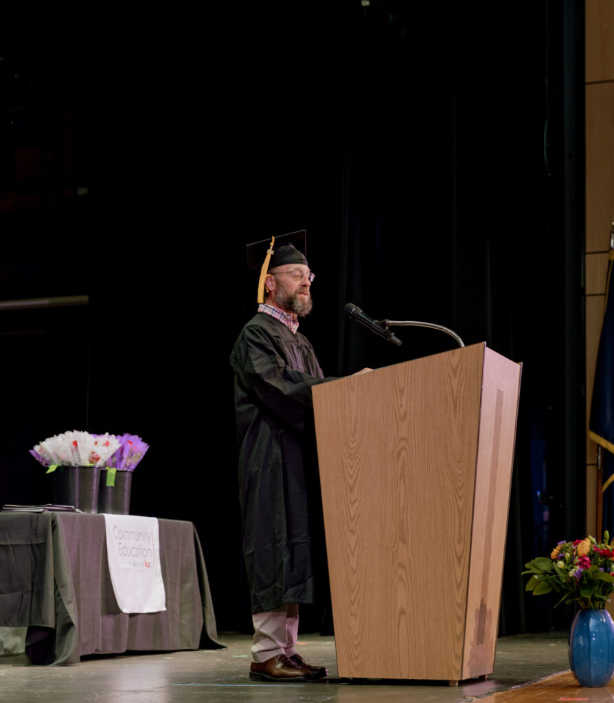 Male graduate speaking at a podium